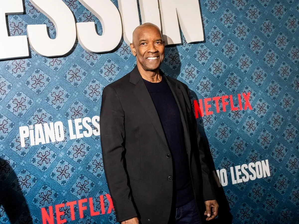 Denzel Washington posing in a black suit at the premiere of 'The Piano Lesson'.