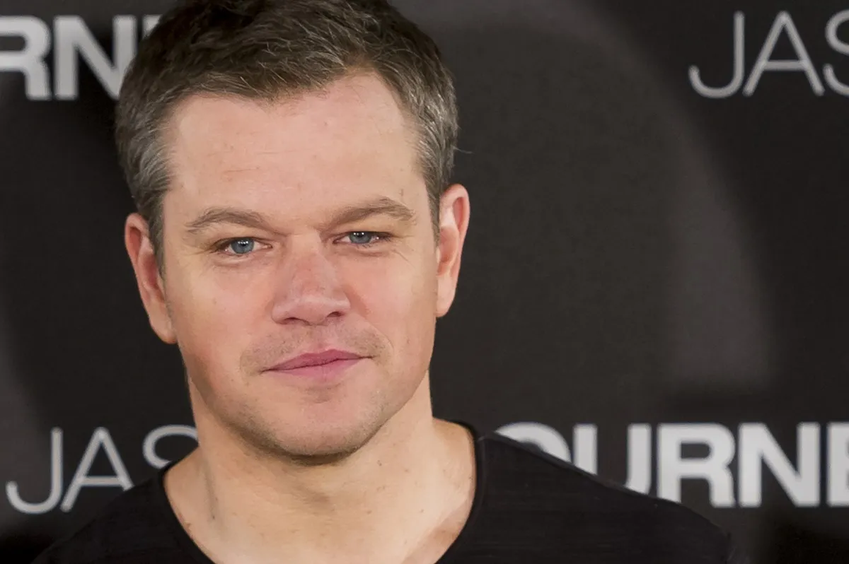 Matt Damon posing at the 'Jason Bourne' premiere in a black shirt.