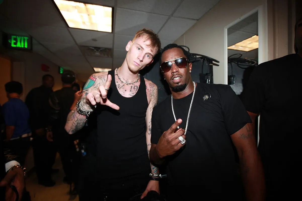 Machine Gun Kelly and Sean Diddy Combs posing in matching-colored outfits at the BET Hip Hop Awards.