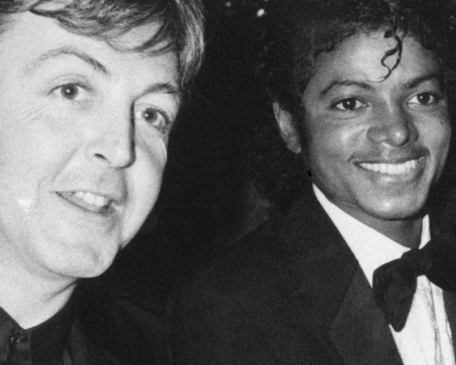 The Beatles' Paul McCartney and "Thriller" singer Michael Jackson smiling