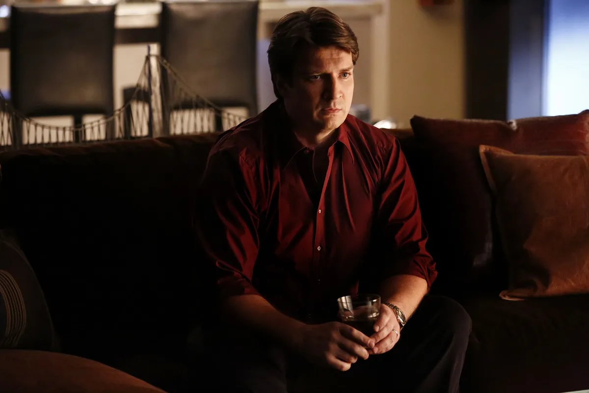 Nathan Fillion sitting down in an episode of 'Castle'.