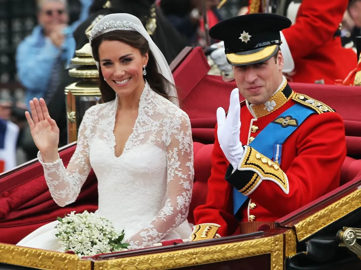 Prince William and Kate Middleton during carriage procession to Buckingham Palace following their wedding at Westminster Abbey