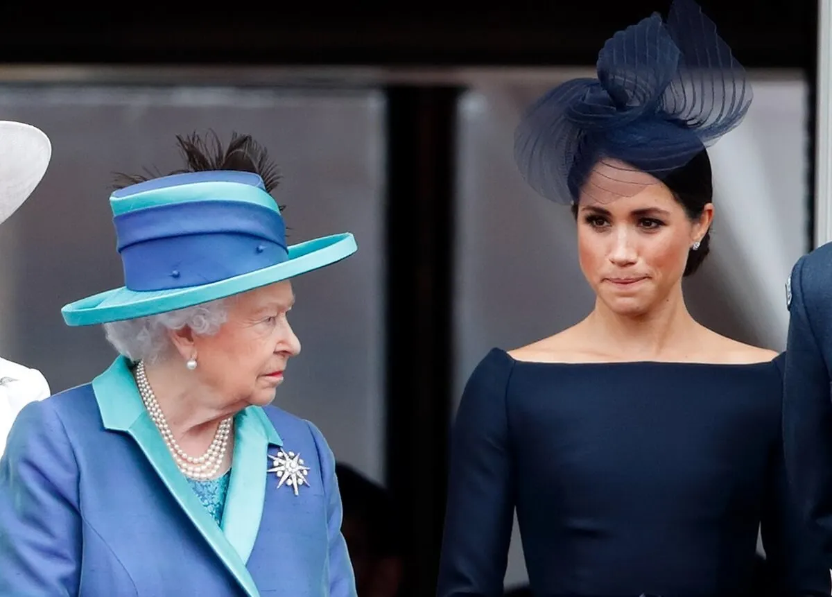 Queen Elizabeth II and Meghan Markle watch a flypast from the balcony of Buckingham Palace