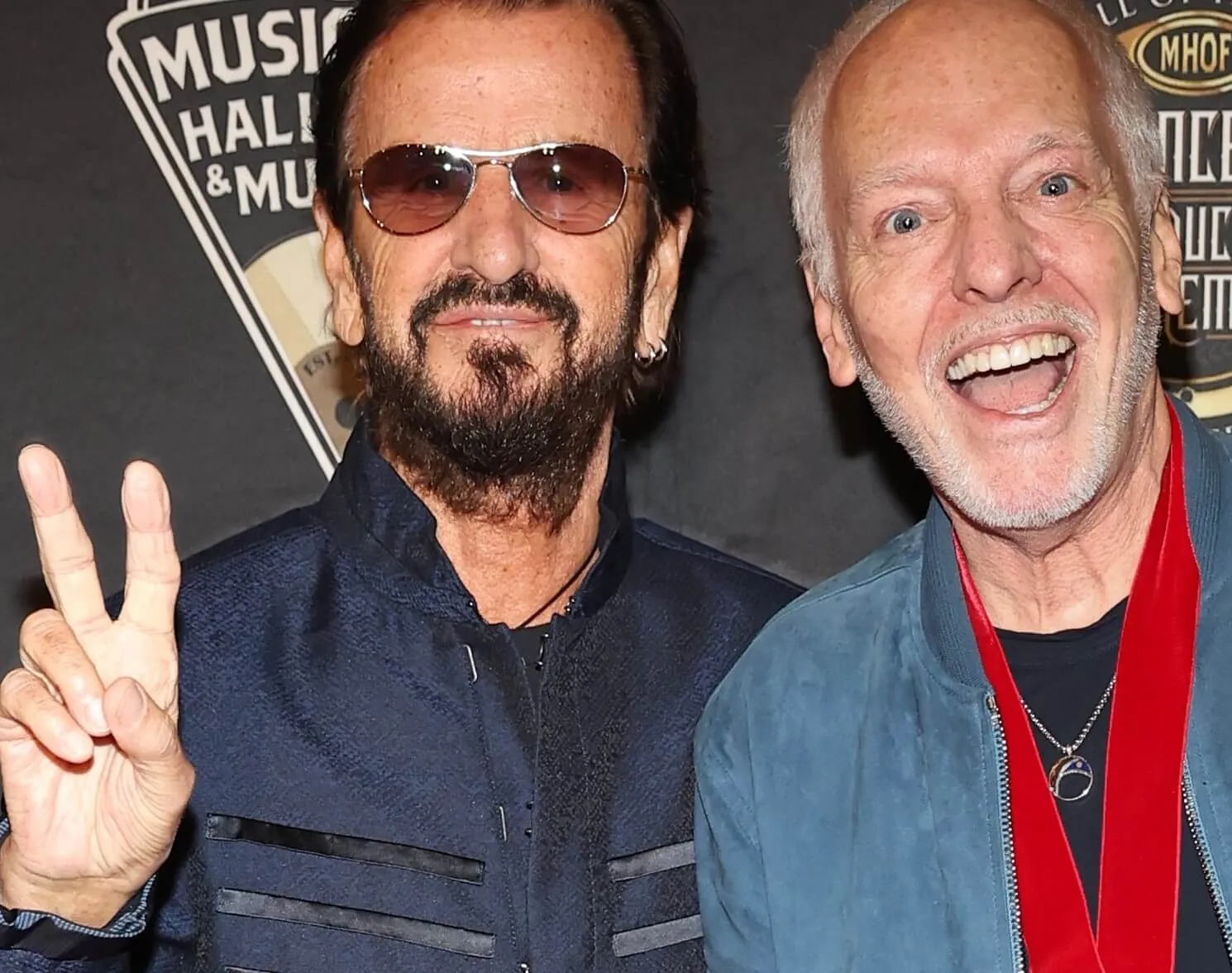 Ringo Starr standing next to Peter Frampton