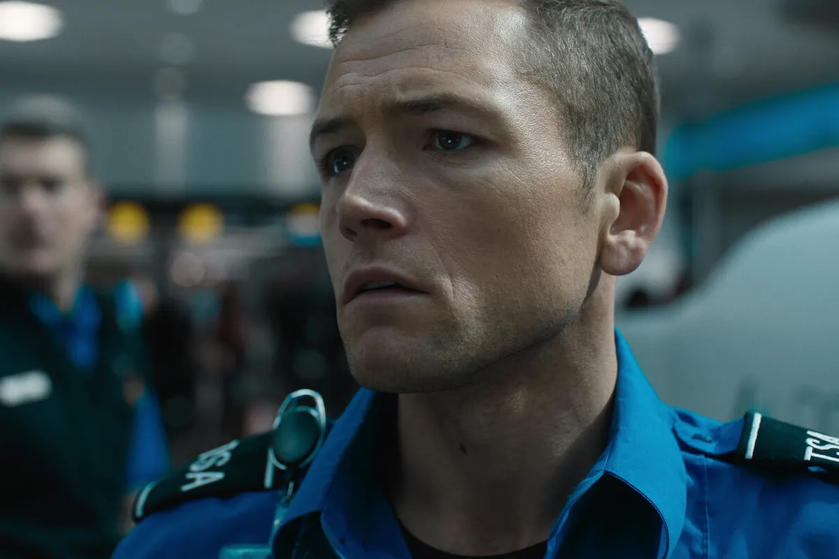 Taron Egerton, who didn't want to go 'full on Tom Cruise' in 'Carry-On,' runs in a scene from the Netflix movie.