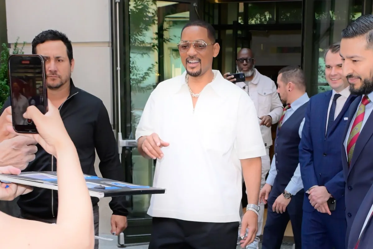 Wearing a white button-up and black pants, Will Smith exits his hotel in SoHo in 2024